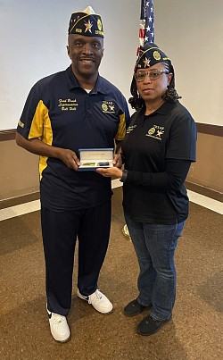 20th District Commander-Elect Billy Hill being presented is with a gold pen set as a congratulatory token by Post 828 Coommander Amanda Parham.